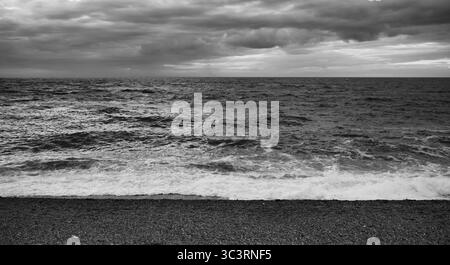 Surf, plage, plage de galets, Etretat, mer, nuages, noir et blanc, Normandie, Seine-maritime, France Banque D'Images