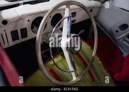 Intérieur de voiture classique vintage avec volant, héritage de style rétro de voiture Oldtimer, changement de vitesse manuel, passion automobile intemporelle, histoire automotiv Banque D'Images