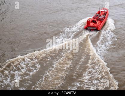 Bateau touristique Thames Rockets passant sous le London Bridge sur la Tamise. Banque D'Images