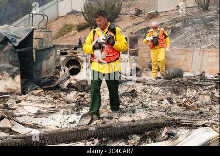 27 juillet 2018 - Redding, Californie, États-Unis - Ed Boontjer, avec le Shasta County Search and Rescue Carrie Fluffy, à travers les restes d'une maison incendiée dans le quartier de Lake Redding Estates à Redding, en Californie. Le chat a survécu aux flammes et a été réuni avec ses propriétaires, qui ont également perdu leur maison dans l'incendie. L'incendie a coûté la vie à deux personnes et est maintenant estimé à 44 450 acres et seulement 3% contenu. (Crédit image : © Mark McKenna via ZUMA Wire) Banque D'Images
