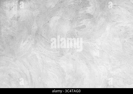 Une vue détaillée d'une surface en béton texturé blanc avec des motifs tourbillonnants doux, idéal pour une utilisation comme arrière-plan ou élément de design, soulignant ne Banque D'Images