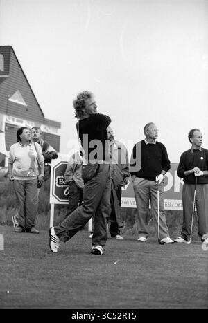 Équipe de golf, dont Bernhard Langer (frappe la balle), 23-07-1991 Whizgle News, Dutch Desk, pays-Bas, 1950-2000 Un groupe de spectateurs regarde attentivement un golfeur se balancer sur le parcours, montrant un moment de concentration et d'anticipation au milieu d'une atmosphère de tournoi. Banque D'Images