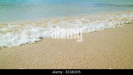 Vagues de l'océan bleu s'affrontant sur la plage de sable Banque D'Images