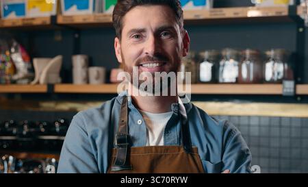 Heureux caucasien travailleur d'âge moyen sourire portrait entrepreneur propriétaire de petite entreprise Guy garçon homme croiser les bras dans le café café restaurant masculin Banque D'Images