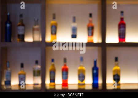 Fond défocalisé de diverses bouteilles d'alcool dans un bar ou un restaurant. Image maquette de publicité de bar. Banque D'Images