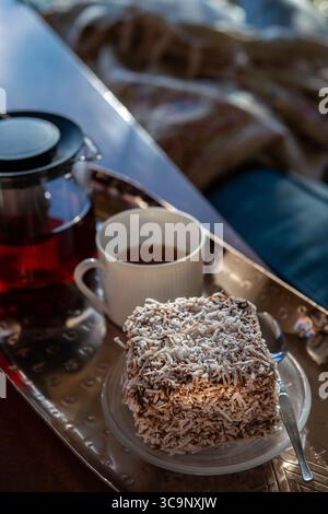 Un gros plan légèrement décentré d'un délicieux gâteau lamington australien, recouvert d'une généreuse couche de noix de coco desséchée Banque D'Images