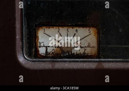 Vieux comparateur rouillé sur four à gaz dans la cuisine, gros plan, appareil vintage, panneau sale avec des chiffres Banque D'Images