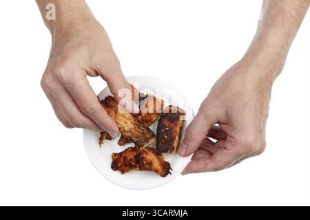 Un homme plus âgé choisit un morceau de poisson de mer saumon grillé aux épices pour le petit déjeuner. Isolé sur un gros plan de studio blanc Banque D'Images