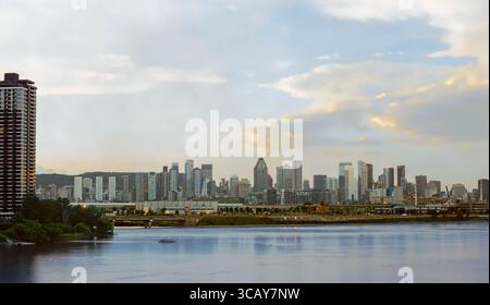 Superbe horizon de Montréal au coucher du soleil avec les gratte-ciel du centre-ville reflétant sur le fleuve St-Laurent. Magnifique paysage urbain québécois montrant l'architecture urbaine du Banque D'Images