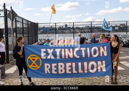13 septembre 2023, New York, New York, États-Unis : des activistes de extinction Rebellion NYC manifestent à l'héliport JRA West 30th Street ciblant les émissions de luxe telles que les trajets en hélicoptère. Une bannière dit â€œExtinction Rebellion.â€ les gens tiennent des drapeaux avec le symbole extinction Rebellion. Les manifestants appellent à la fin des combustibles fossiles et des émissions de carbone inutiles provenant des modes de vie de luxe pour faire face à l’urgence climatique et protéger les générations futures. La manifestation est l'une des nombreuses manifestations organisées par des groupes climatiques en prévision de la marche de masse ''Biden : End Fossil Fuels'' à New York le 7 septembre Banque D'Images