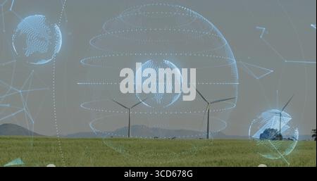 Globe holographique planant projetant des lignes de réseau et des noeuds au-dessus d'un champ herbeux avec des éoliennes Banque D'Images