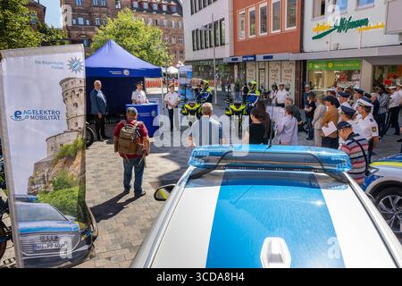 Bayerische Polizei startet Pilotprojekt mit vollelektrischen Motorrädern, Nürnberg, 12.082.2025 Blick auf die öffentliche Vorstellung des Pilotprojekts Elektromobilität BEI der Bayerischen Polizei in der Nürnberger Innenstadt. Innenminister Joachim Herrmann und Vertreter des Polizeipräsidiums Mittelfranken präsentieren der interessierten Öffentlichkeit zwei neue elektrische Polizeimotorräder des Herstellers Zero. IM Vordergrund ist ein Einsatzfahrzeug mit Blaulicht zu sehen, links ein Banner der AG Elektromobilität der Bayerischen Polizei. Die Veranstaltung verdeutlicht den Weg zu einem klimaf Banque D'Images