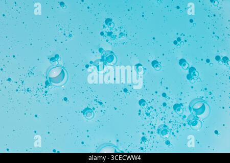 Gros plan de gel cosmétique bleu avec des bulles créant une texture fascinante. Les gouttelettes de gel translucides offrent une esthétique apaisante et rafraîchissante dans a vi Banque D'Images