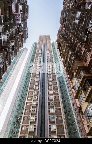 Les bâtiments résidentiels imposants à faible angle montent en flèche, mettant en valeur l'architecture urbaine dense de Hong Kong. Cette perspective ascendante met en évidence l'uniqu de la ville Banque D'Images