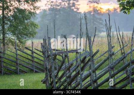 Clôture traditionnelle en bois en épicéa et genévrier au lever du soleil. Ce genre de clôtures était la manière normale d'escrime en Scandinavie dans les temps anciens. Banque D'Images