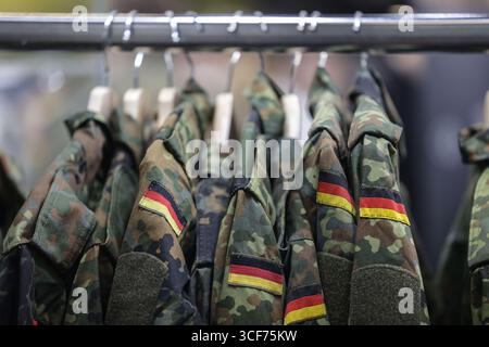 Cologne, Allemagne. 21 août 2025. Vestes de terrain suspendues sur le stand de la Bundeswehr. L'armée allemande est à la recherche de nouvelles recrues au salon des jeux vidéo de la Gamescom. Crédit : Oliver Berg/dpa/Alamy Live News Banque D'Images