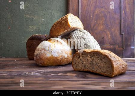 Série de pain artisanal rustique avec pains entiers et pain tranché sur planches et tables en bois. Style de boulangerie ferme avec des textures naturelles, ingr organique Banque D'Images