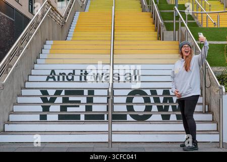 Wembley Park, Londres, Royaume-Uni. 22 août 2025. Les premiers fans de Coldplay arrivent à Wembley Park. Avant la série de concerts de groupes au stade de Wembley, à partir de ce soir, le super fan arrivant tôt, Aniko de Suisse, visite l'installation d'art public de Wembley Park, en collaboration avec Pantone, 'YELLOW 25' sur les marches espagnoles, un gradient de 58 pas de jaunes pour célébrer le 25e anniversaire de la chanson de Coldplay 'Yellow'. Crédit : Amanda Rose/Alamy Live News Banque D'Images