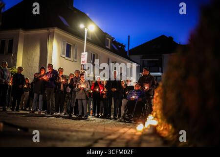 Solingen, Allemagne. 23 août 2025. Ce soir-là, à 17 h 9,37, des gens tiennent des bougies à la mémoire des victimes de l'attentat terroriste perpétré à Solingen il y a un an. Crédit : Christoph Reichwein/dpa/Alamy Live News Banque D'Images