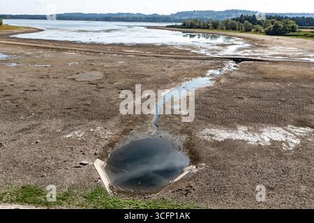 Les faibles niveaux d’eau et le lit du lac desséché sont exposés au lac Chew Valley, dans le Somerset Nord, où Bristol Water rapporte des stocks d’eau (au 11/08/2025) à 44 % comparativement à 73 % l’an dernier en 2024. Date de la photo : dimanche 24 août 2025. Banque D'Images