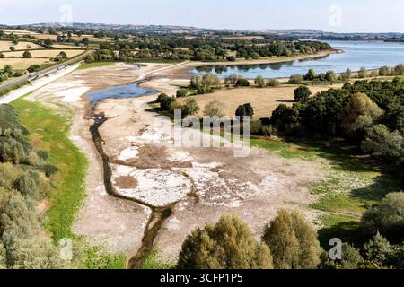Les faibles niveaux d’eau et le lit du lac desséché sont exposés au lac Chew Valley, dans le Somerset Nord, où Bristol Water rapporte des stocks d’eau (au 11/08/2025) à 44 % comparativement à 73 % l’an dernier en 2024. Date de la photo : dimanche 24 août 2025. Banque D'Images
