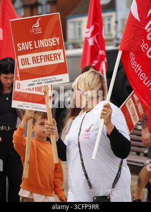 Cleethorpes, Royaume-Uni . 24 août 2025. De gauche à droite, un manifestant tient des pancartes et des drapeaux pendant le rassemblement de protestation de Save Lindsey Oil Refinery – manifestation Cleethorpes contre la fermeture de Central Promenade. Crédit : Freddie Yeo/Alamy Live News Banque D'Images