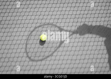 Terrain de tennis avec raquette placé sur le court à Riyad, Arabie Saoudite, montrant des équipements sportifs et une surface de jeu extérieure. Banque D'Images