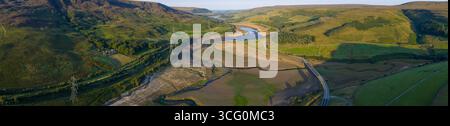 La vue aérienne par drone capture la dure réalité de la sécheresse sévère au réservoir Woodhead près de Glossop, révélant de vastes étendues de terre sèche et fissurée. Banque D'Images