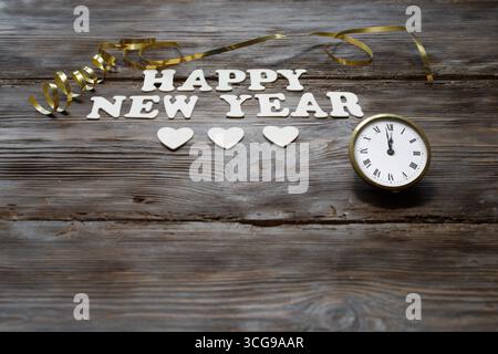 Inscription bonne année avec de petits coeurs sur un fond en bois foncé Banque D'Images