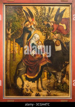 La fuite en Egypte, panneau de l'autel Melk par Jörg Breu l'ancien, peint en 1502. L'œuvre représente la Vierge Marie avec l'enfant Jésus chevauchant un âne, accompagné de Joseph et entouré d'anges offrant des branches de dates. Banque D'Images