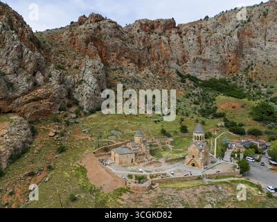 Églises historiques encastrées dans un paysage de montagne rocheuse, entourées d'une végétation verte et tranquillement isolée, vue aérienne, Monastère Noravank, Surb A. Banque D'Images
