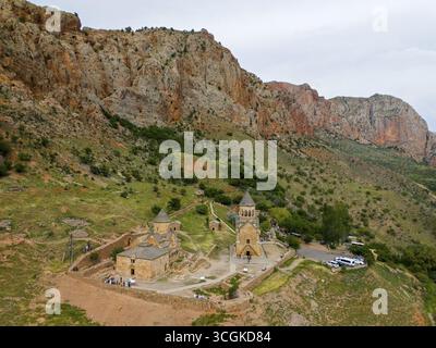Paysage de l'église en face de formations rocheuses spectaculaires, entouré par la nature verte, dans un endroit isolé de montagne, vue aérienne, Monastère Noravank, o Banque D'Images