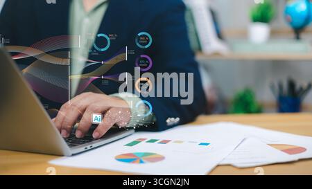 Homme d'affaires utilisant un ordinateur portable avec une interface alimentée par IA montrant l'analyse de données et des graphiques, symbolisant la transformation numérique, la veille économique, machin Banque D'Images
