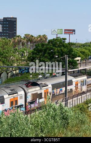 Viladecans. Barcelone - 29 août 2025 : la surface d'un train de voyageurs sert de toile à l'expression de la sous-culture du graffiti, un chemin de fer commun Banque D'Images