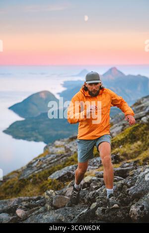 Homme athlète trail running dans les montagnes du coucher du soleil voyage en Norvège vacances d'aventure active, voyageur masculin randonnée solo sain mode de vie extrême fi voyage Banque D'Images