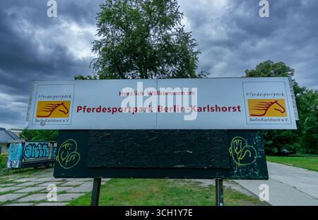 Panneau du Pferdesportpark Berlin-Karlshorst avec logo de cheval et ciel nuageux, entrée au site équestre historique. Banque D'Images