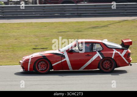 Alors qu'il quitte la piste, le pilote d'une Porsche 968 Red remercie la foule enthousiaste Banque D'Images