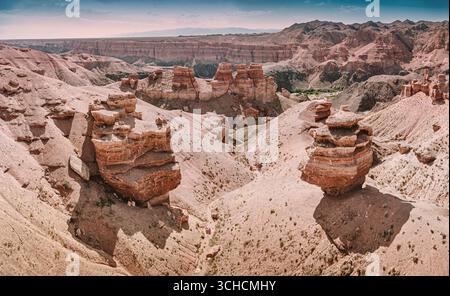 Les majestueuses formations rocheuses du Canyon de Charyn, au Kazakhstan, créent un paysage à couper le souffle sous la vaste étendue du ciel Banque D'Images