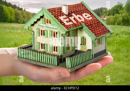 Ein Haus erben, Symbolfoto Erbschaftssteuer und Freibeträge, München, septembre 2025 Deutschland, München, septembre 2025, ein Haus erben, OMAS Häuschen auf der hand eines Erben, renovierungsbedürftiger Altbau vor bayerischer Landschaft, Symbolfoto Erbschaftssteuer, Vorschlag Söders, daß künftig jedes Bundesland selbst die Steuersätze festlegen darf, Fotomontage, Bayern *** hériter une maison, photo symbolique impôt sur les successions, Munich, septembre 2025 Allemagne, Munich, septembre 2025, hériter d'une maison, grand-mamans petite maison de la main d'un héritier, immeuble ancien en besoin de rénovation en fr Banque D'Images
