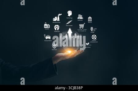 Concept de croissance de l'économie des industries mondiales avec le monde éclatant dans la main de l'homme d'affaires, la technologie, la finance, les soins de santé, la fabrication, et économi dans le monde entier Banque D'Images