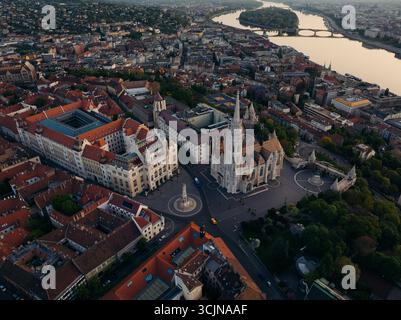 Vue aérienne de l'église Matthias et du bastion des pêcheurs se dressent fièrement contre la courbe douce du Danube, une symphonie de pierre et d'eau, Budapest, Budapest, Hongrie. Banque D'Images