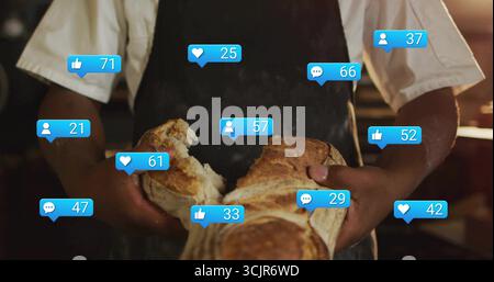 Arrachant le pain rustique boulanger adulte portant tablier à la cuisine de boulangerie, avec des icônes de réaction flottantes Banque D'Images