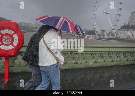 Londres, Royaume-Uni. 10 septembre 2025. Les gens s'abritent avec des parapluies sur le pont de Westminster lors d'une averse torrentielle alors que le temps instable revient à Londres et au Royaume-Uni. Crédit Amer Ghazzal/Alamy Live News Banque D'Images