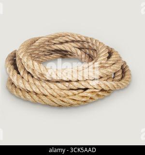 Une corde enroulée faite de fibres naturelles, couramment utilisée dans diverses applications comme la voile, l'escalade et l'artisanat. Banque D'Images