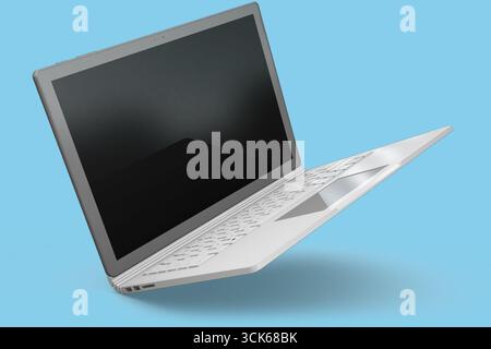 Un ordinateur portable moderne affiché sous un angle, mettant en valeur son design élégant et son écran ouvert. Banque D'Images