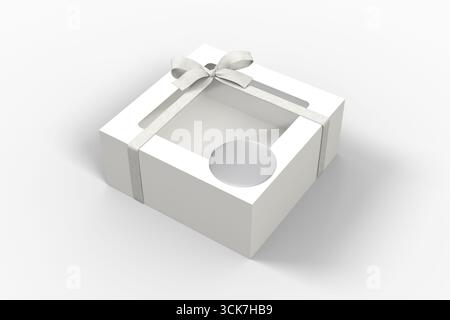 Un coffret cadeau blanc avec un dessus transparent et un ruban, adapté pour emballer des friandises ou de petits objets. Banque D'Images