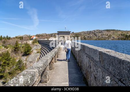 Femme marchant à travers le barrage de Vale do Rossim, sur la lagune Man Made l'un des points les plus élevés du Portugal Banque D'Images