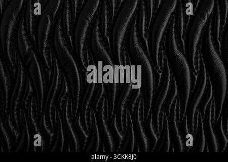 Motif abstrait avec des points sur cuir noir, formes de flamme ornementales Banque D'Images