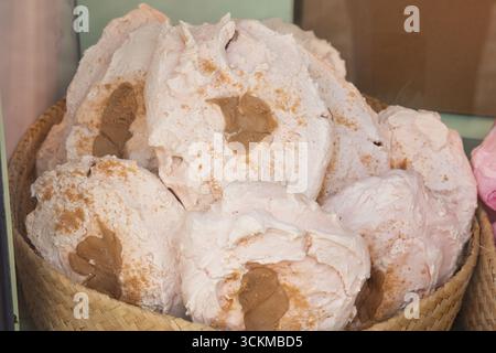 28 août 2025, Bruges, Belgique — Meringues brun clair fourrées de caramel et de sucre saupoudré disposées dans un panier. Banque D'Images