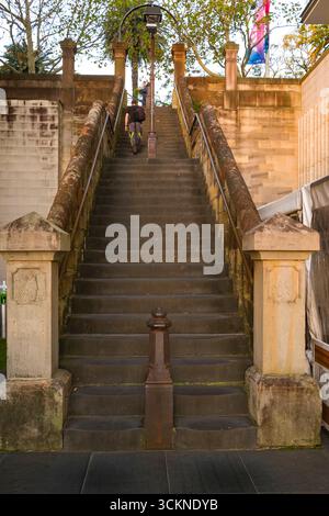 Un grand escalier en pierre orné de balustrades ornées et d'un lampadaire central menant vers le haut, entouré d'une architecture urbaine historique, Sydney Banque D'Images
